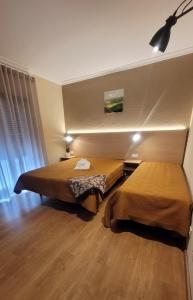 a hotel room with two beds in a room at Ferrinho in Guarda