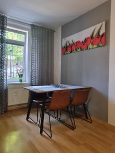 a dining room with a table and chairs and a window at Apartmány Černý Tulipán 1 in Plzeň