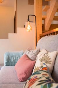 a room with a couch with pillows and a lamp at The Wooden House VV in Las Palmas de Gran Canaria