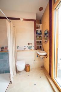 a bathroom with a toilet and a sink at The Wooden House VV in Las Palmas de Gran Canaria