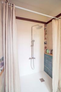 a shower in a bathroom with a shower curtain at The Wooden House VV in Las Palmas de Gran Canaria +39 photos