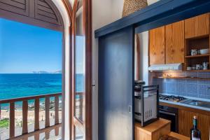 a kitchen with a view of the ocean from a balcony at Alguerhome Casa Blu sea view in Alghero