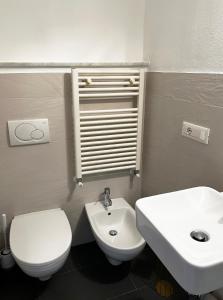 y baño con aseo blanco y lavamanos. en Il Dolce Far Niente, La Serra di Lerici, en Lerici