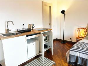 a small kitchen with a sink and a counter top at Il Dolce Far Niente, La Serra di Lerici in Lerici