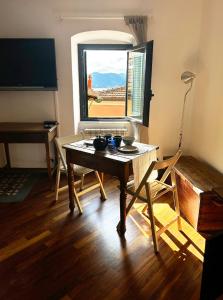 a living room with a table and a window at Il Dolce Far Niente, La Serra di Lerici in Lerici