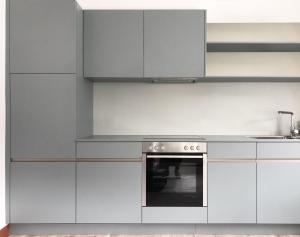 a kitchen with white cabinets and an oven at Villa Anna in Solda