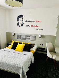 a bedroom with a bed with a sign on the wall at Piano in Nowy Sącz