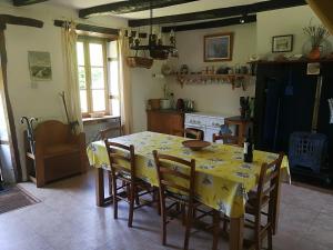 a dining room with a yellow table and chairs at La Petite Maison Pont Blanchard, in Pléaux +19 photos