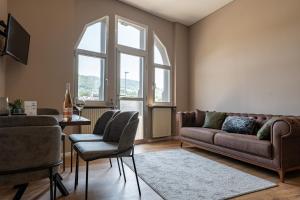 een woonkamer met een bank en een tafel bij Moselresidenz Bellevue Alf Apartment Moselblick in Alf