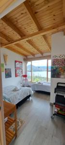 a bedroom with two beds and a large window at Villa Vista in Guatavita