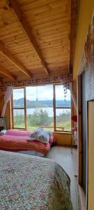 a bedroom with a bed and a large window at Villa Vista in Guatavita