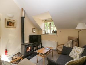 a living room with a wood stove at The Loft At Nordrach Lodge in Bristol