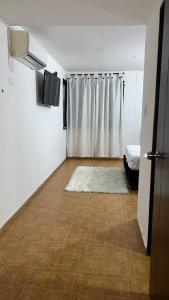 a room with a shower and a wooden floor at Casa completa al frente del centro comercial alamedas in Montería