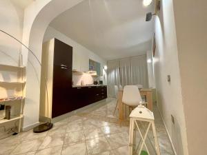 a living room with a kitchen and a dining room at Arquer43 - Cagliari Old Town in Cagliari