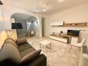 a living room with a couch and a table and a tv at Arquer43 - Cagliari Old Town in Cagliari