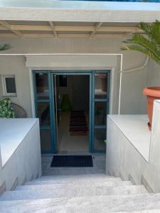 an open door of a house with a staircase at Αρέθουσα Jungle τριάρι 65τμ. in Chalkida