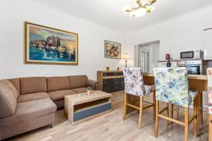 a living room with a couch and a table at Villa Carolina in Rijeka