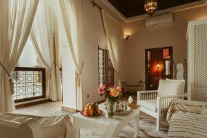 - un salon avec un canapé et une table dans l'établissement Riad Dar Dialkoum, à Marrakech