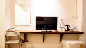 a computer monitor sitting on a desk in a room at Yoont Hotel in Ban Khun Yuam