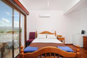 a bedroom with a bed and a balcony at Bella Rosa hotel Cyprus in Coral Bay