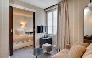 a hotel room with a bed and a mirror at Le Senat in Paris