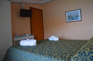 Postel nebo postele na pokoji v ubytování Hotel Miramare