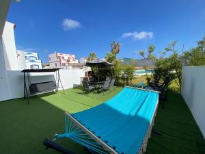 a blue hammock on the roof of a house at Casa com terraço e piscina Sagres in Sagres