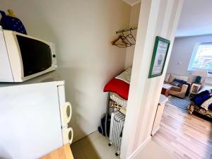 a small room with a tv on top of a refrigerator at Kwatera prywatna na Kaszubach 