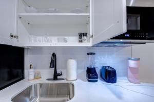 a kitchen counter with a sink and aaucet at Pink Flamingo Studio Apartment in Galveston