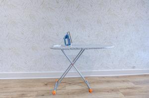 a table with a pair of scissors on it in front of a wall at Summer Tropics Studio Apartment Two Queen Beds in Galveston