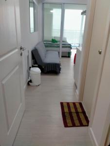a hallway with a room with a chair and a window at SM Bicutan Affordable Rooms in Manila