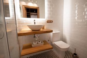 a bathroom with a sink and a toilet at Miraverde Liérganes in Liérganes