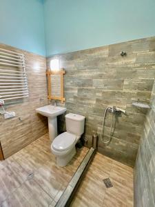 a bathroom with a toilet and a sink at Guest House Savane in Gori