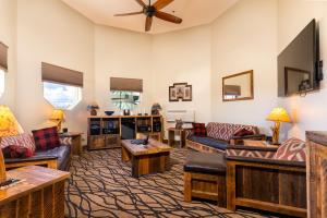 a living room with couches and a flat screen tv at The Grand Hotel at the Grand Canyon in Tusayan