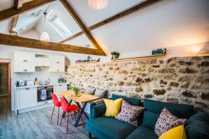 a living room with a couch and a table at The Farm at Avebury in Marlborough