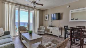 a living room with a view of the ocean at Majestic Sun 1006B in Destin