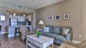 a living room with a couch and a table at Majestic Sun 1006B in Destin