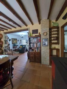 a living room with a book shelf and a fireplace at Casa Rural El Olivar Ronda in Arriate