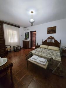 a bedroom with a large bed in a room at Casa Rural El Olivar Ronda in Arriate