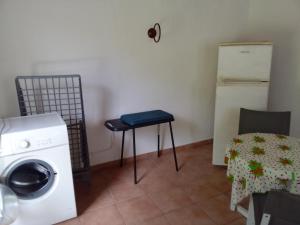 a laundry room with a washing machine and a table at Malaka Rose in Sainte-Rose