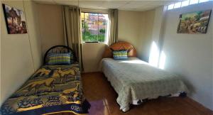 Carlos Guest House 2 Cusco客房内的一张或多张床位