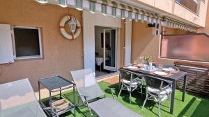 a balcony with a table and chairs on a patio at Regina - Victoria in Sainte-Maxime