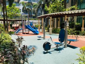 a playground with a slide and a swing at Studio 8th FL with Balcony across Terminal 3 Airport in Manila