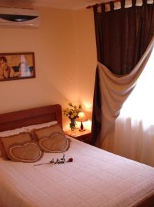 a bedroom with a bed with two hearts on it at Sinay Hotel in Poltava