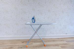 a table with a pair of scissors on it in front of a wall at Cheetah Crush Studio Apartment in Galveston