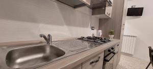 a kitchen with a sink and a stove at Molfetta Central Station Studio in Molfetta +20 photos