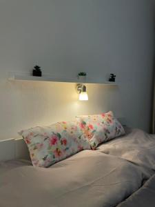 a bed with a pillow with flowers on it at Apartment Nitra-city centre in Nitra