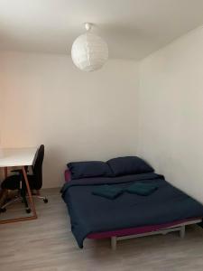 a bedroom with a bed and a desk and a lamp at Apartment Nitra-city centre in Nitra