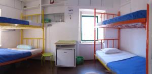 a room with two bunk beds and a desk at Guest House Periko in Split