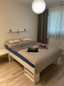 a bedroom with a large bed with a light at Apartment Nitra-city centre in Nitra